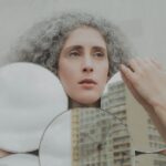 woman holding white round mirror